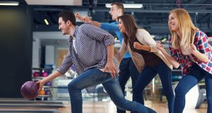 friends-cheering-their-friend-while-throwing-bowling-ball-300x200